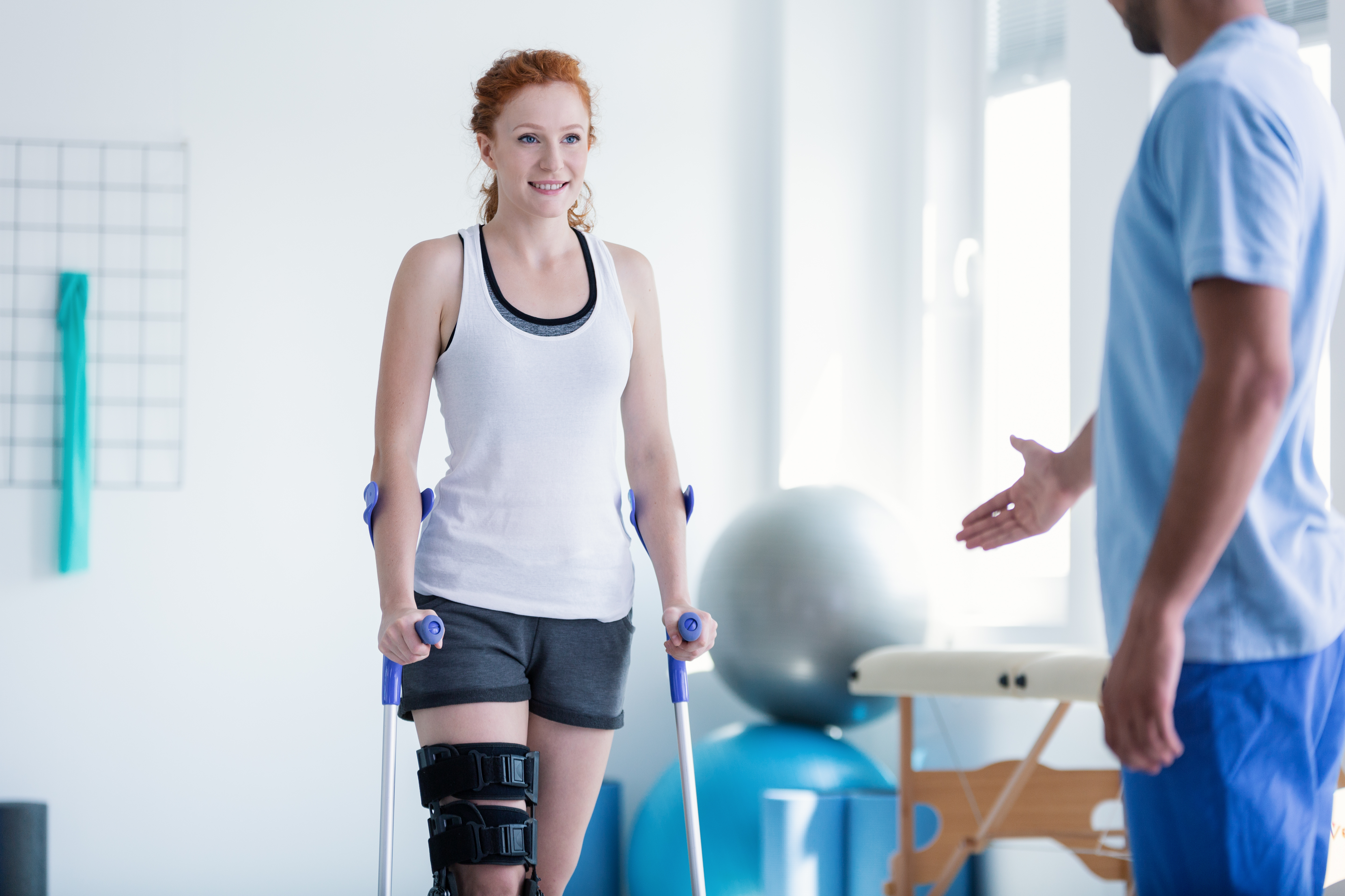 Woman walking with crutches during physiotherapy